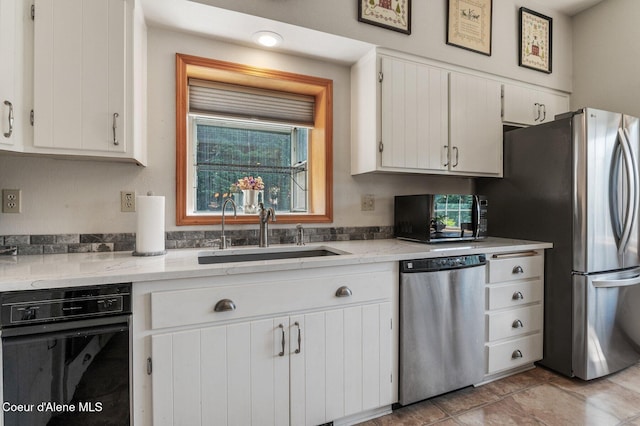 512 River Dr, Clark Fork, ID 83811 - kitchen with appliances with stainless steel finishes, white cabinetry, plenty of natural light, and light stone countertops