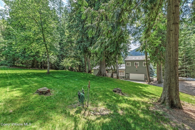 512 River Dr, Clark Fork, ID 83811 - view of green lawn featuring a garage