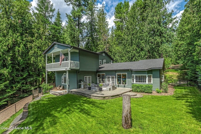 512 River Dr, Clark Fork, ID 83811 - back of house featuring an outdoor living space, a balcony, a patio area, and roof with shingles