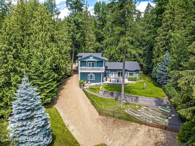 512 River Dr, Clark Fork, ID 83811 - back of property with a balcony, a porch, and a wooded view
