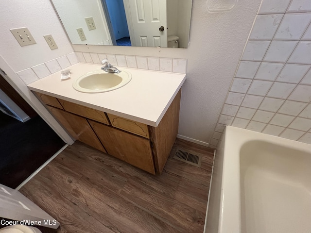 3848 E 2nd Ave, Post Falls, ID 83854 - bathroom with wood finished floors, a tub to relax in, and vanity