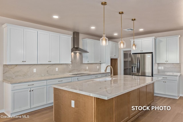 L1B1 Sylvan Rd, Athol, ID 83801 - kitchen with stainless steel fridge with ice dispenser, wall chimney range hood, light wood-style floors, backsplash, and recessed lighting