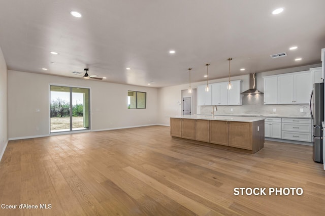 L1B1 Sylvan Rd, Athol, ID 83801 - kitchen featuring wall chimney exhaust hood, open floor plan, light countertops, recessed lighting, and light wood-style flooring
