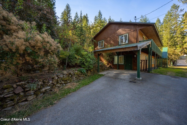 2711 S Carpenter Loop, Post Falls, ID 83854 - rustic home with asphalt driveway and a metal roof