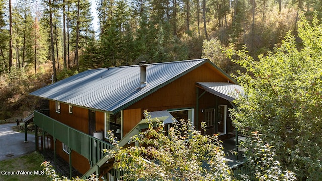 2711 S Carpenter Loop, Post Falls, ID 83854 - view of property exterior with a metal roof and a forest view