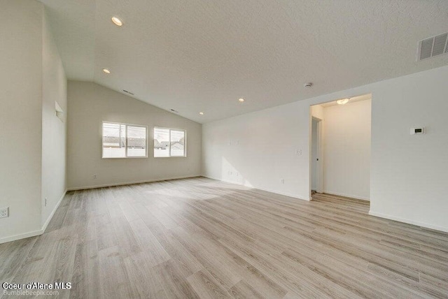 4300 N Arrowleaf Loop, Post Falls, ID 83854 - spare room with light wood finished floors, a textured ceiling, recessed lighting, and lofted ceiling