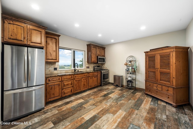 5969 W Highland Dr, Coeur Dalene, ID 83814 - kitchen with appliances with stainless steel finishes, recessed lighting, decorative backsplash, dark wood-style floors, and dark stone counters