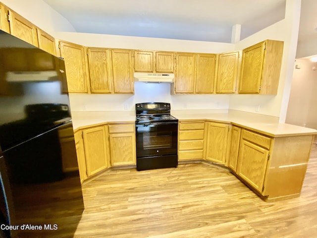 3674 E 2nd Ave, Post Falls, ID 83854 - kitchen featuring black appliances, under cabinet range hood, light wood-style floors, light brown cabinets, and light countertops