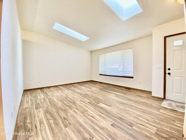 3674 E 2nd Ave, Post Falls, ID 83854 - spare room featuring a skylight, light wood-type flooring, and lofted ceiling