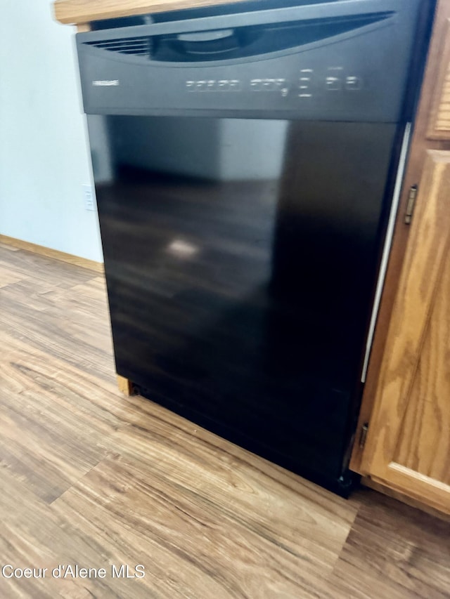 3674 E 2nd Ave, Post Falls, ID 83854 - kitchen view of light wood finished floors and black dishwasher