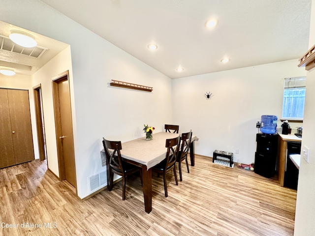 3674 E 2nd Ave, Post Falls, ID 83854 - dining area with light wood-type flooring, vaulted ceiling, and recessed lighting