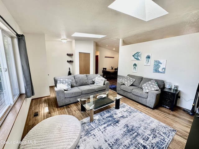3674 E 2nd Ave, Post Falls, ID 83854 - living room with a skylight, wood finished floors, and healthy amount of natural light
