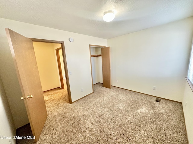 3674 E 2nd Ave, Post Falls, ID 83854 - unfurnished bedroom featuring light colored carpet and a closet
