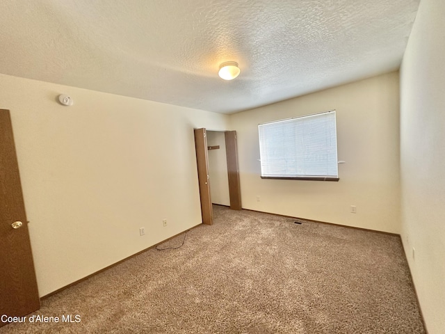 3674 E 2nd Ave, Post Falls, ID 83854 - carpeted spare room with a smoke detector and a textured ceiling