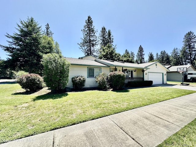 3674 E 2nd Ave, Post Falls, ID 83854 - ranch-style house featuring asphalt driveway, a garage, and a front lawn