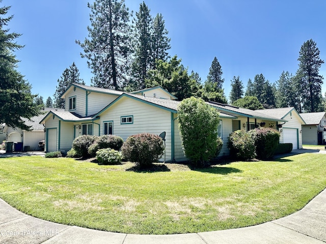 3674 E 2nd Ave, Post Falls, ID 83854 - view of side of home featuring an attached garage, concrete driveway, and a lawn