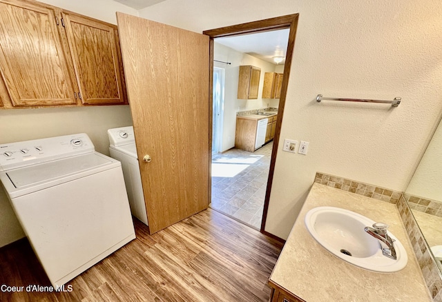3674 E 2nd Ave, Post Falls, ID 83854 - laundry room with washing machine and clothes dryer and light wood-type flooring
