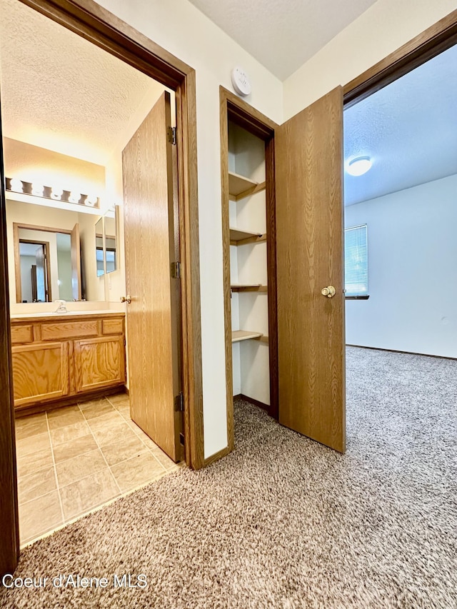 3674 E 2nd Ave, Post Falls, ID 83854 - corridor featuring light carpet and a textured ceiling
