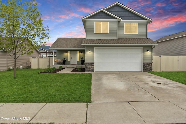 6595 W Covenant St, Rathdrum, ID 83858 - craftsman-style house with stone siding, an attached garage, covered porch, and concrete driveway
