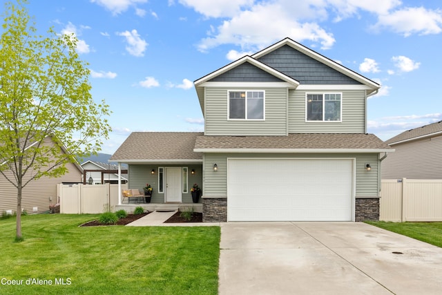 6595 W Covenant St, Rathdrum, ID 83858 - craftsman-style house with a garage, stone siding, covered porch, concrete driveway, and roof with shingles