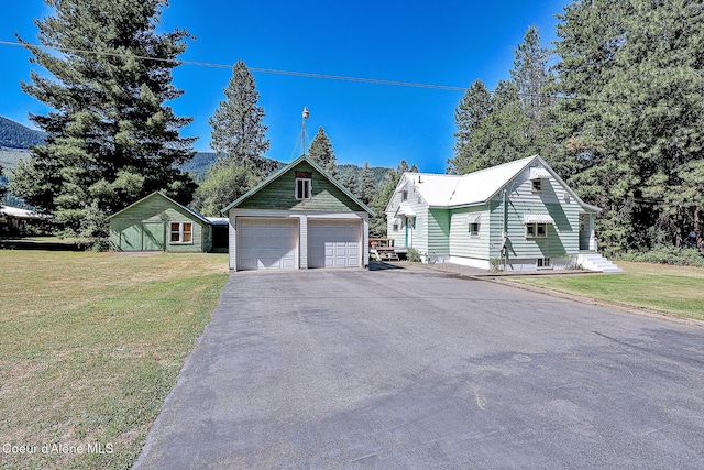 67 Nuchols Gulch Rd, Osburn, ID 83849 - view of front of house with an outbuilding, a front yard, and a detached garage