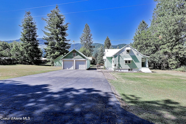67 Nuchols Gulch Rd, Osburn, ID 83849 - view of front of house with an outdoor structure, driveway, and a front yard