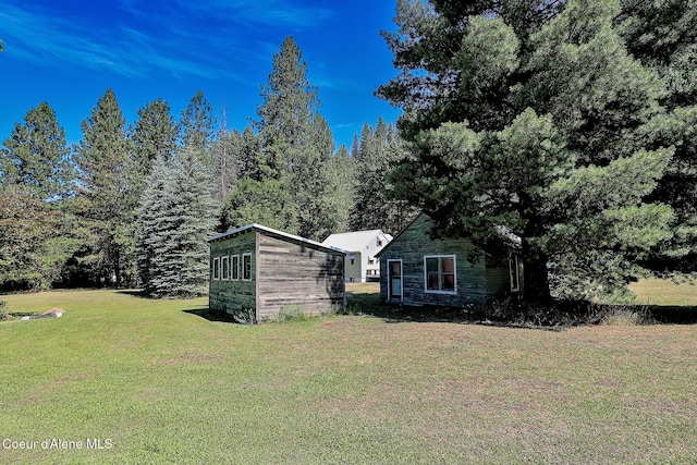 67 Nuchols Gulch Rd, Osburn, ID 83849 - view of side of property with a yard and an outbuilding