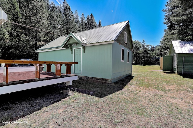 67 Nuchols Gulch Rd, Osburn, ID 83849 - view of side of home featuring a wooden deck, a yard, and a metal roof