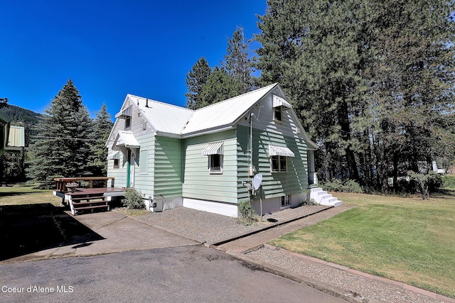 67 Nuchols Gulch Rd, Osburn, ID 83849 - view of front of house with a front lawn and a metal roof