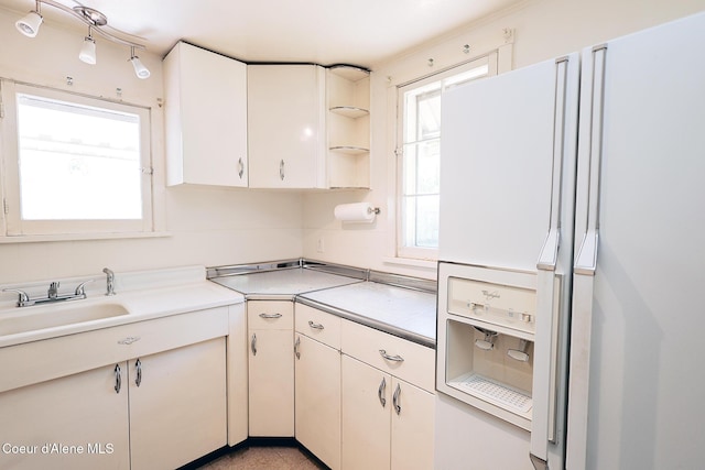 67 Nuchols Gulch Rd, Osburn, ID 83849 - kitchen with white refrigerator with ice dispenser, light countertops, open shelves, and white cabinetry