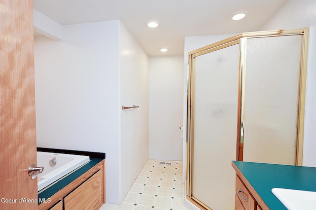 67 Nuchols Gulch Rd, Osburn, ID 83849 - bathroom featuring a shower stall, vanity, recessed lighting, and a garden tub