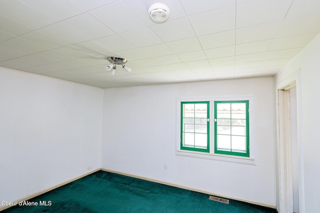 67 Nuchols Gulch Rd, Osburn, ID 83849 - unfurnished room featuring dark colored carpet and a smoke detector