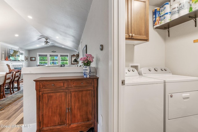 307 S 18th St, Coeur Dalene, ID 83814 - washroom with separate washer and dryer, a ceiling fan, light wood-style flooring, and cabinet space