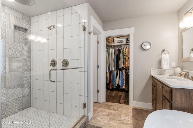 307 S 18th St, Coeur Dalene, ID 83814 - full bathroom with a stall shower, vanity, and a walk in closet