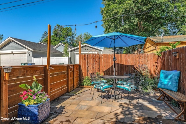 307 S 18th St, Coeur Dalene, ID 83814 - fenced backyard with outdoor dining space, a patio area, and a storage shed