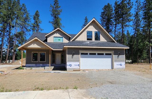 2003 E Plaza Ct, Post Falls, ID 83854 - property under construction featuring covered porch, a garage, driveway, board and batten siding, and a shingled roof