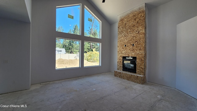 2003 E Plaza Ct, Post Falls, ID 83854 - unfurnished living room with high vaulted ceiling and a stone fireplace