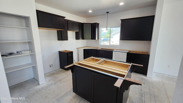 2003 E Plaza Ct, Post Falls, ID 83854 - kitchen with dark cabinetry, a center island, hanging light fixtures, and recessed lighting
