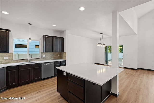 2003 E Plaza Ct, Post Falls, ID 83854 - kitchen featuring stainless steel dishwasher, backsplash, light countertops, light wood-style floors, and recessed lighting