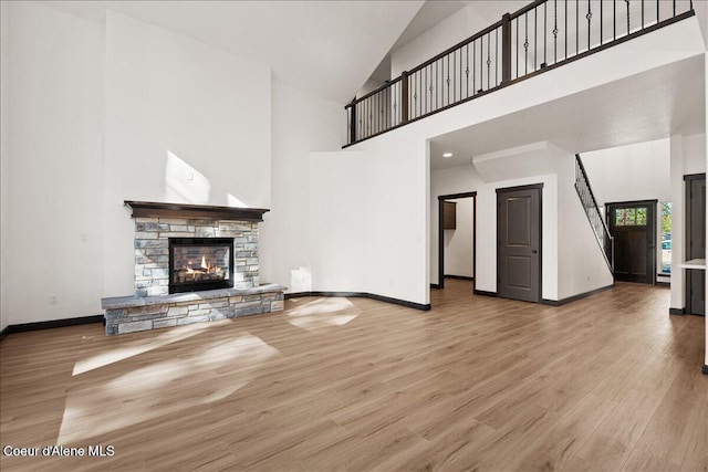 2003 E Plaza Ct, Post Falls, ID 83854 - unfurnished living room with high vaulted ceiling, wood finished floors, and a fireplace