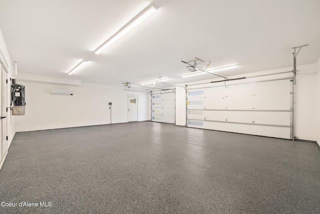 11551 N Bluejay Loop, Hayden, ID 83835 - garage featuring an AC wall unit and a garage door opener