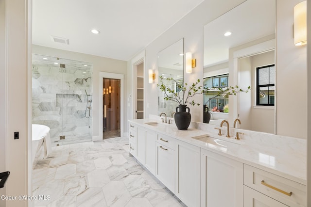 11551 N Bluejay Loop, Hayden, ID 83835 - full bathroom with a marble finish shower, double vanity, recessed lighting, marble finish flooring, and a soaking tub