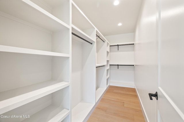 11551 N Bluejay Loop, Hayden, ID 83835 - walk in closet with light wood finished floors and a barn door
