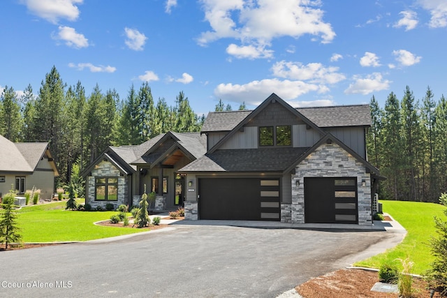 11551 N Bluejay Loop, Hayden, ID 83835 - view of front of property featuring stone siding, board and batten siding, asphalt driveway, and a front yard