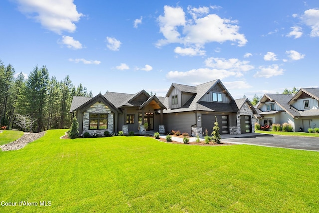 11551 N Bluejay Loop, Hayden, ID 83835 - view of front of property featuring stone siding, driveway, a front lawn, and an attached garage
