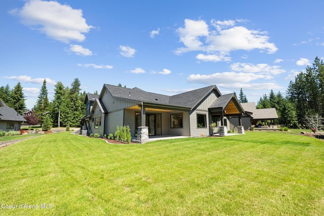 11551 N Bluejay Loop, Hayden, ID 83835 - back of house with board and batten siding, a yard, roof with shingles, and a patio