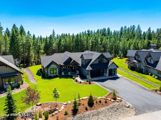 11551 N Bluejay Loop, Hayden, ID 83835 - view of front of property with stone siding, asphalt driveway, a front yard, and a garage