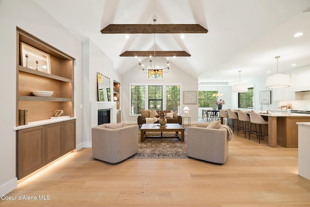 11551 N Bluejay Loop, Hayden, ID 83835 - living room featuring light wood-style flooring, a chandelier, recessed lighting, and a glass covered fireplace