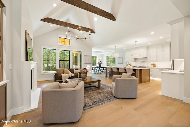 11551 N Bluejay Loop, Hayden, ID 83835 - living area with beam ceiling, high vaulted ceiling, light wood-type flooring, recessed lighting, and a chandelier