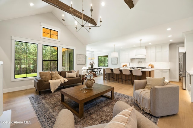 11551 N Bluejay Loop, Hayden, ID 83835 - living room with recessed lighting, light wood finished floors, high vaulted ceiling, a chandelier, and beam ceiling